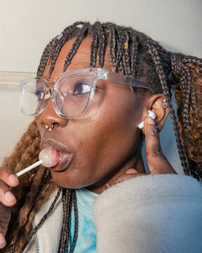 Young woman enjoying lollipop in an urban setting