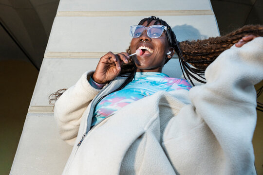 Carefree gen Z woman enjoying urban lifestyle