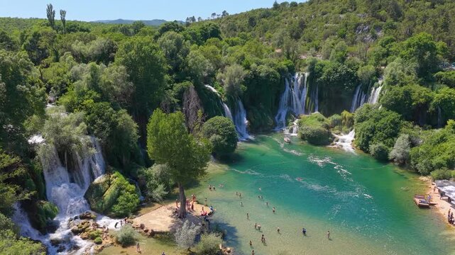 Kravica Waterfall, Bosnia and Herzegovina - June 7, 2026: Elevated drone view of visitors at the iconic Kravica Waterfall