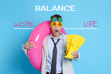 Work-life balance. Young businessman with inflatable ring, party sunglasses and flippers on light blue background © New Africa