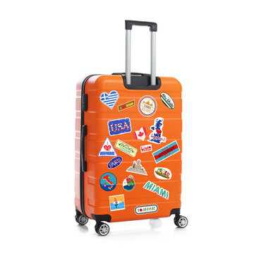 Orange suitcase with stickers from trips to visited places isolated on white