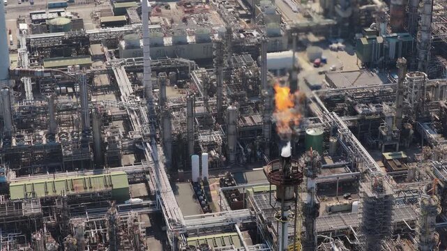 Industrial Plant Flare Stack Burning Gas in Daytime Aerial View