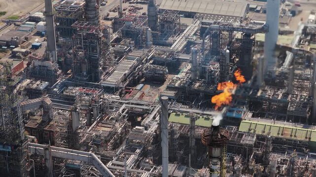 Massive Oil Refinery Flares Excess Gas From Tall Stack During Daytime