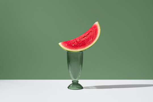 Minimal still life with watermelon slice in green glass