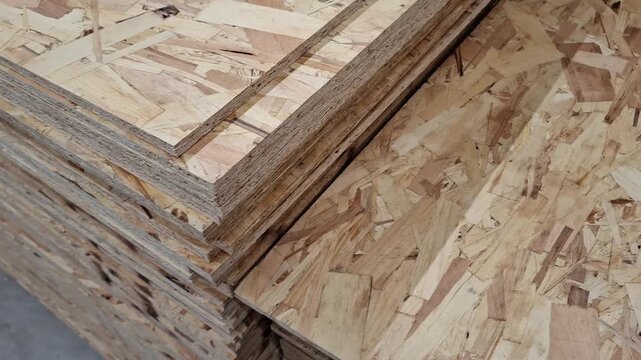 construction material texture. Layered OSB sheets at a carpentry workshop, construction supplies, chipboard hardware store inventory, natural brown wooden background, industry.
