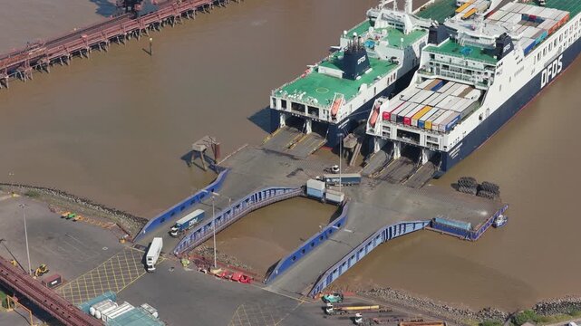 Busy Cargo Ferries Loading and Unloading Trucks at a Large European Port Terminal