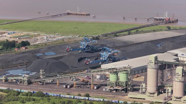 Coal Terminal Operations by River in Daylight With Trains and Shipping Pier