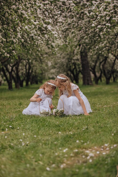 Happy family moment in blooming spring orchard scene