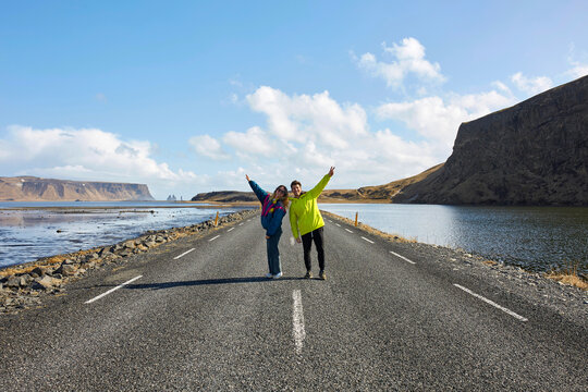 Iceland couple on open road celebrating scenic adventure