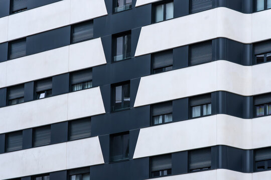 Modern building facade with geometric panels and windows