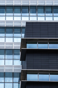 Modern glass office facade with geometric window pattern