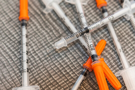 Insulin syringes with orange caps for pets and humans