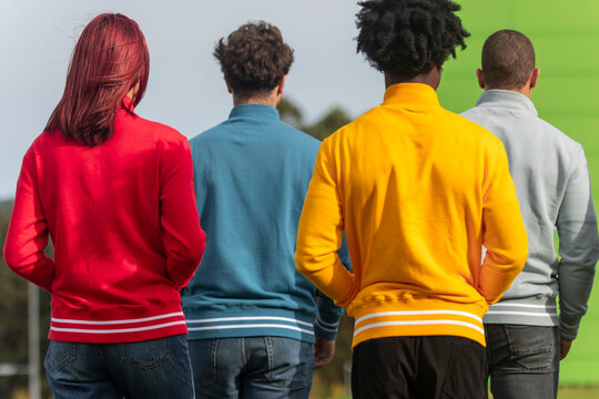 Group of people wearing colorful sweatshirts outdoors