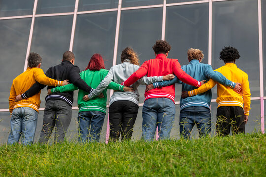 Group unity in colorful sweatshirts outdoors