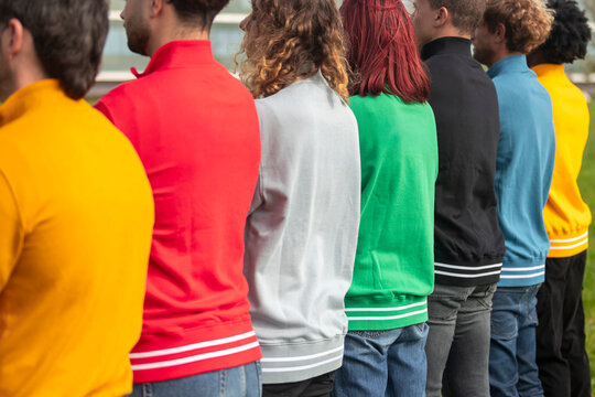 Diverse group wearing colorful sweatshirts in a line