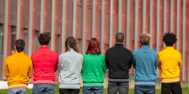 Diverse group wearing colorful sweatshirts outdoors