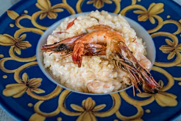 Creamy risotto topped with grilled prawns served at a restaurant, Cannes, France © SvetlanaSF