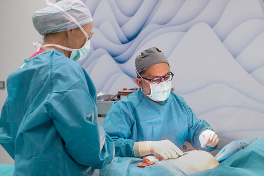 Surgical team performing breast reduction procedure