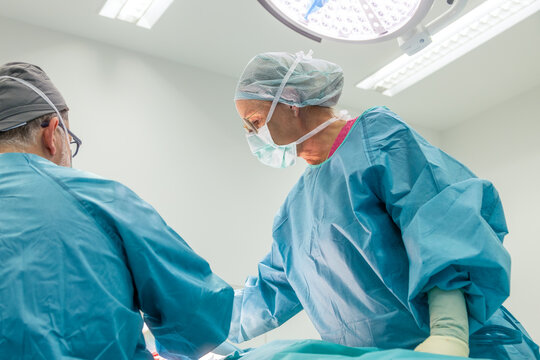 Surgeons performing breast reduction operation
