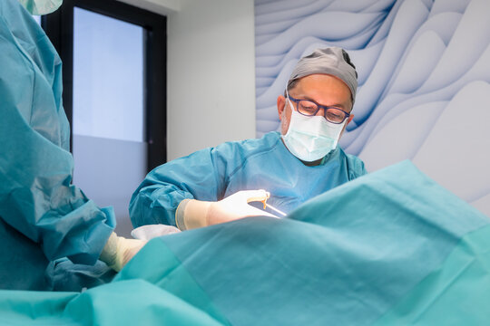 Surgeon performing breast reduction surgery