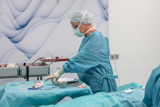 Surgeon performing breast reduction surgery in hospital