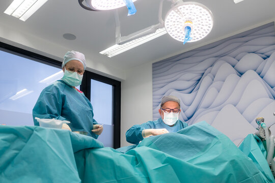 Surgical team performing breast reduction procedure