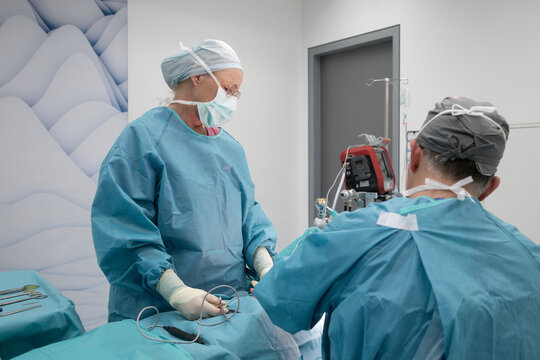 Surgical team performing breast reduction procedure