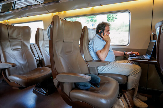 Businessman multitasking during a train journey