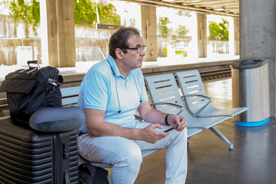 Mature traveler waiting for train at station