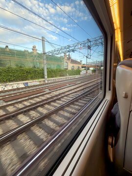 Scenic view from a train window capturing railway tracks