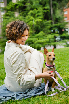 Woman with her adopted dog relaxing in the park