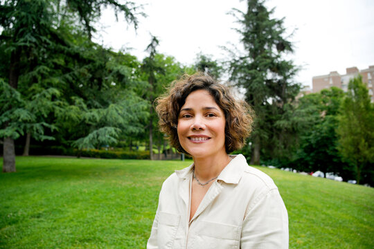 Smiling woman enjoying a peaceful day in the park
