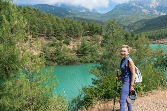 Woman hiking in mountainous landscape with lake