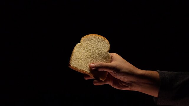 Slice of bread flipping in the air on black background
