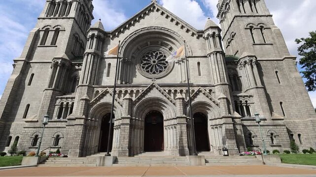 Stone cathedral with twin towers and rose window.