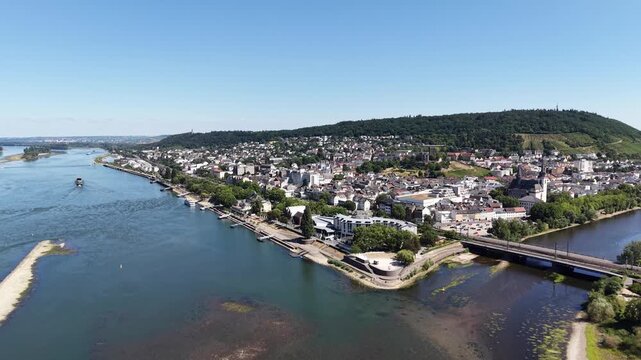 Drone aerial view of Bingen am Rhein at the confluence of the Rhine and Nahe rivers in Germany. Scenic cityscape with historic architecture, waterfront, bridges, green hills and vineyards in the Upper