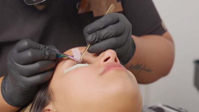 Beautician applying eyelash extensions in a beauty salon