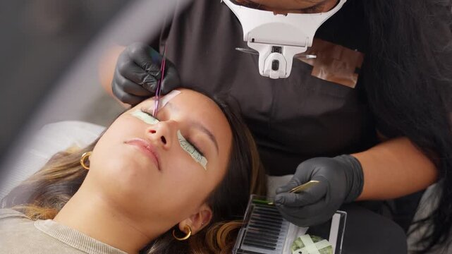 Professional lash technician applying eyelash extensions in a beauty salon