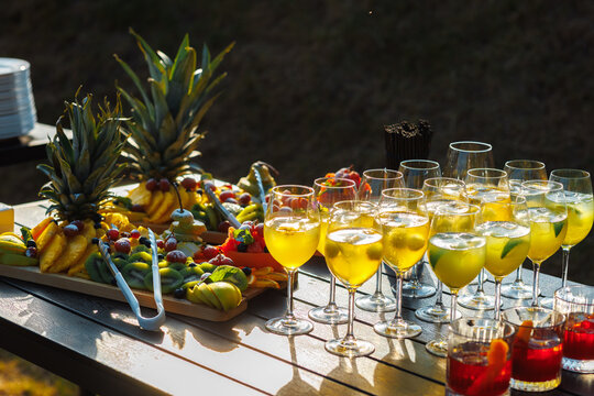 Summer catering buffet with tropical fruit platter and refreshing cocktails.