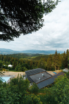 Luxury mountain resort with a swimming pool and scenic panoramic view.