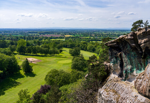 Expansive view of the dramatic sandstone cliffs and lush golf course landscape at historic Hawkstone Park Follies at the Ravens Shelf
