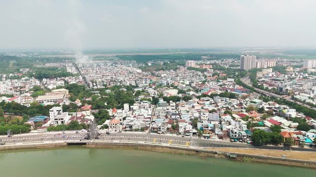 Bien Hoa City, Dong Nai, Vietnam &ndash; 4K aerial drone footage of Dong Nai River, city skyline, riverside neighborhoods, riverside houses, bridge and urban landscape