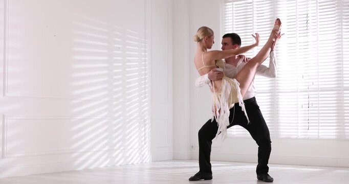 Couple of professional dancers training in studio