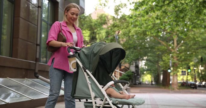 Baby carriage. Mother walking with her child in stroller outdoors