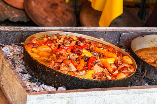 Coked vegetable and meat stew meal inside metal pot sold on local fair