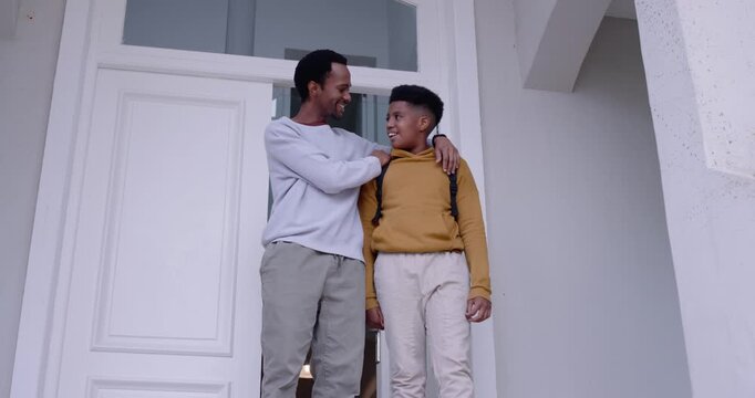 African American dad and son on porch, dad patting shoulder, teen leaving for school with backpack