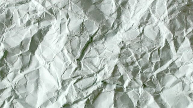 Motion Texture Template of Crinkled Crumpled Sheet of Paper. Seamless Loop of Textured Background with Stop Motion Style Animation