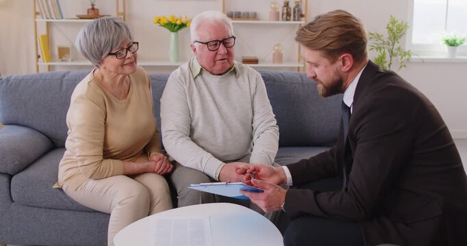 Senior old family couple discussing documents, clients guidance, consulting on health, financial insurance deal agent lawyer, mature customers meeting manager, investment, medical contract, advising