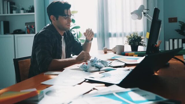 Professional interior designer working on palette and crumpled paper. Top view of skilled business man run out of idea while sleeping at meeting table. Project manager crumpled and throw paper