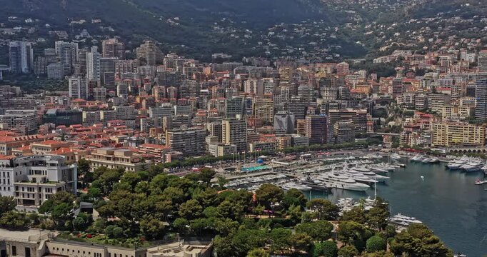 Monaco Aerial v17 establishing shot drone fly around la condamine neighborhood capturing famous port hercule and hillside downtown cityscape - July 2021